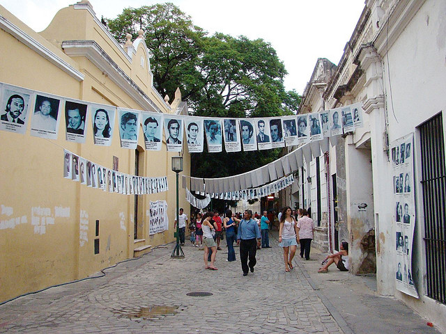 Photos of those disappeared by the military junta commemorate the Dirty War in Argentina. (Photo by Pablo Flores, via Flickr)